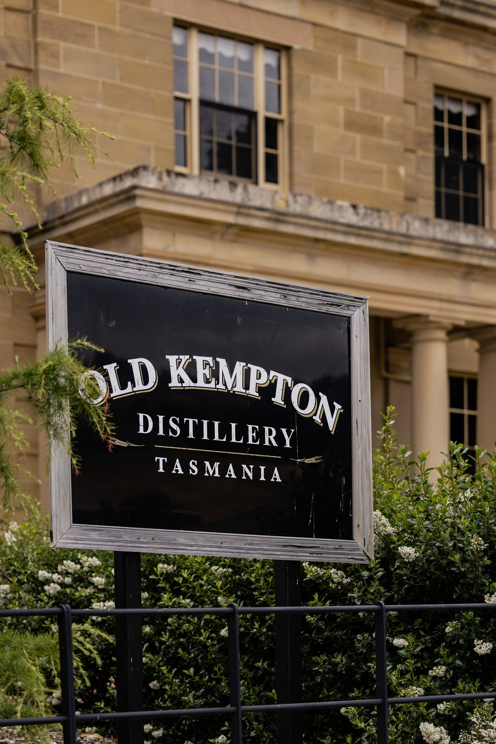 Sign for Old Kempton Distillery Tasmania in front of a building