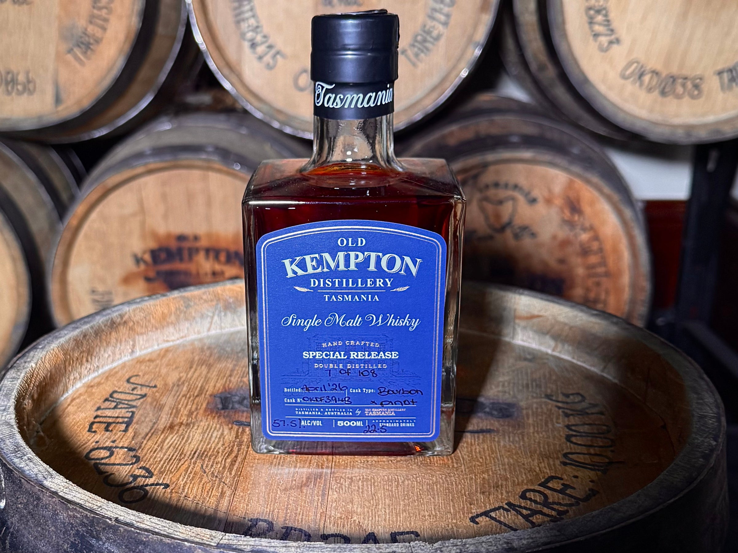Bottle of Old Kempton Distillery Tasmanian Single Malt Whisky on wooden barrels